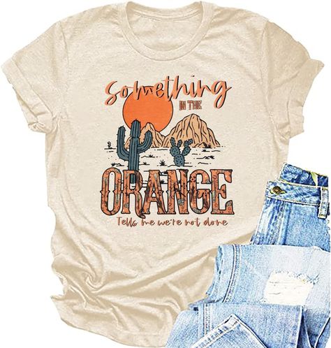 PRICES MAY VARY. Feature:Women western shirt,something in the orange letter print tees,cowboy country music tee tops, western desert graphic t shirt. Round neck, retro vintage western design, casual loose fit, high-quality material texture. Style: Country music Western style T-shirt, casual hippie and denim top. It is very suitable for mothers, wives, daughters, sisters, grandmothers, girlfriends, and friends to express their love for country music. Occasion: This country music enthusiast shirt Something In The Orange, Country Concert Shirts, Country Music Shirt, Western Graphic Tees, Country Music Shirts, Retro Western, Music Tees, Country Concert, Vintage Cowboy