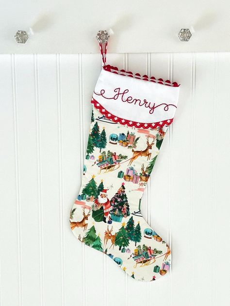 Our beautifully quilted Christmas stockings measure 20" diagonally from bottom of loop to tippy toe. Order with or without a matching red gingham bow. Our signature ric rac trim, custom hand embroidered name, red gingham trim and quilting make this a timeless addition to your Christmas decor. Fully lined with batting and piecing on both sides. You'll love the added surprise of how our cuff overlaps in the back. :: LEAD-TIME :: Please see shipping tab for current lead-time on Christmas stockings. Traditional Stockings Christmas, Hand Sewn Stocking, Embroidered Stockings Christmas, Quilted Christmas Stockings Ideas, Quilted Stockings Christmas, Quilt Stocking, Embroidered Christmas Stocking, Quilted Stocking, Hand Embroidered Name