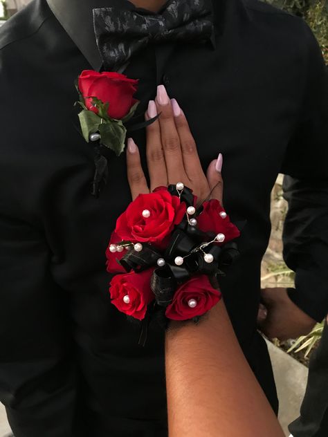 Red roses, all black ribbons with white pearls Red Black Corsage, Red And Black Prom Corsage, Black And Red Prom Flowers, Black And Red Boutonniere, Red And Black Corsage And Boutonniere, Red Flower Corsage, Red Rose Corsage And Boutonniere, Red Hoco Flowers, Prom Corsage And Boutonniere Red