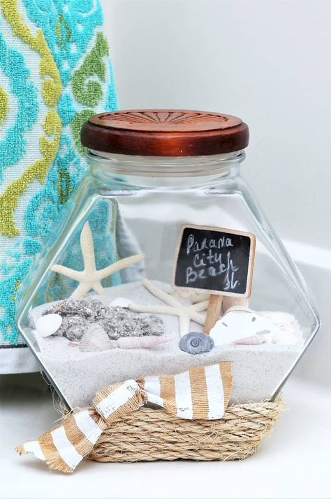 vacation memory jar includes beach sand and seashells along with sisal rope glued to jar Beach Sand Crafts, Beach Memory Jars, Beach Jar, Diy Dollar Tree Centerpieces, Dollar Tree Centerpieces, Memory Jars, Shell Display, Jar Display, Memory Jar