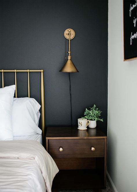 Have a black accent wall in your bedroom? Try pairing it with gold or brass accents, and walnut wood furniture. The paint color featured here is Blackish by Clare. Black Accent Wall Bedroom, Clare Paint, Black Accent Wall, Black Walls Bedroom, Gold Sconces, Walnut Bedroom, Black Accent Walls, Gold Bedroom, Bedroom Accent