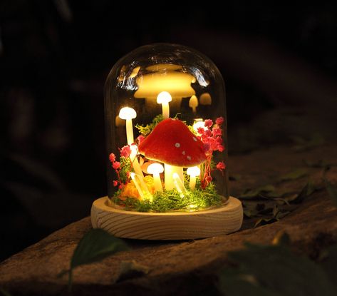 Handmade Crystal With Wild Mushroom Night Light, Flower Fantasy Home Fairy Decor Unique Gift  A magical clearing in the forest unveils a secret world aglow with the delicate radiance of night lamps. The petite white mushrooms, like silent sentinels, guard the entrance to a realm where everlasting dried flowers encapsulated in glass globes tell tales of timeless beauty. Each illuminated secret seems to echo through the night, inviting those who listen to be enchanted by the stories within. I get Goblincore Bedroom Night Lights, Woodland Night Light, Mushroom Nightlight, Moon And Stars Fairy Lamp, Forest Theme Party, Flower Fairy Lamp, Tiny Mushroom, Mushroom Lights, Cadeau Parents