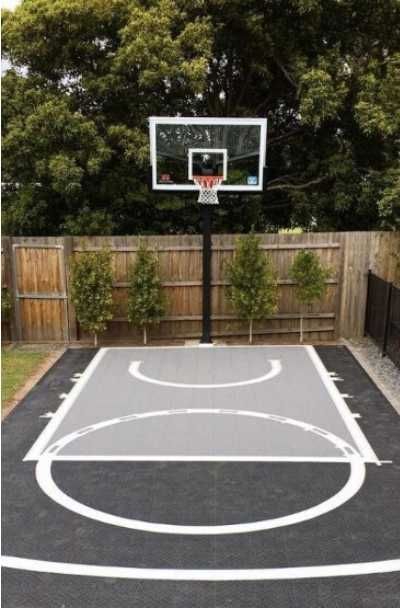 27 Outdoor Home Basketball Court Ideas | Sebring Design Build Basketball Pad In Backyard, Corner Basketball Court, Basketball Area In Backyard, Backyard Tennis Basketball Court, Small Backyard Basketball Courts, Cheap Basketball Court Diy, Home Sports Court Outdoor, Basketball Driveway Ideas, Driveway Basketball Court Ideas