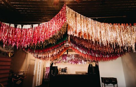 Have you ever wondered what it would be like to get married on Leap Day? Well this whimsical and unique day is perfect inspiration! From the sequin bridal gown and colorful bridesmaids dresses, to the disco balls, confetti and ceiling streamers, it's one big colorful party! Best part? The bride and groom tackled so many wedding DIY projects and pulled them all off! #gws #discowedding #greenweddingshoes #diywedding #whimsicalwedding #funwedding Party Decor Ceiling, Streamer Wedding Decorations, Diy Ceiling Fringe, Ceiling Streamer Decorations, Avant Garde Wedding Decor, Fringe Ceiling Decor, Disco Party Diy, Diy Disco Party Decorations, Disco Brunch