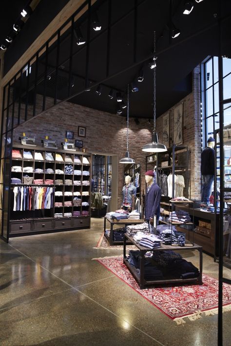 Awesome how the space is divided up with the glass. Concrete floors and brick work are a nice touch. Kolding, Retail Shop Design, Glass Concrete, Clothing Store Interior, Clothing Store Design, Retail Lighting, Retail Interior Design, Jack And Jones, Store Layout