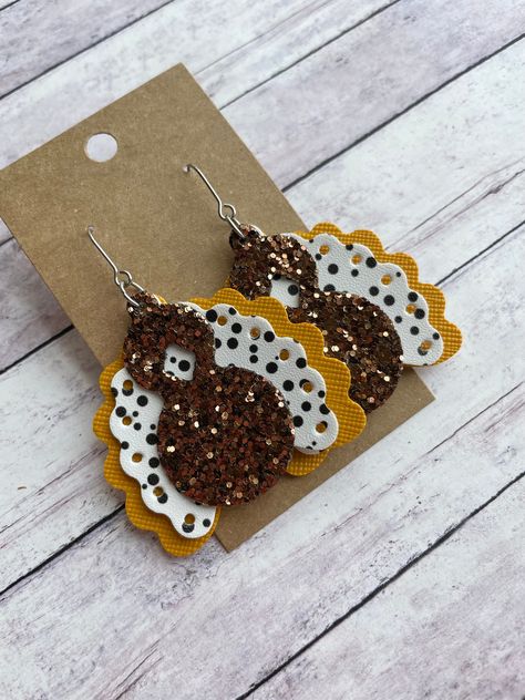 The cutest turkey earrings Made with stainless steel earring findings and faux leather (single-sided). Each pair of earrings will be slightly different because of the variability in the faux leather pattern.  2.5 inches long by 1.875 inches wide. Free shipping on orders $35 and over! Warning: Choking Hazard. Small Parts. Keep out of reach of children under 5 years old. Thanksgiving Earrings Diy, Diy Faux Leather Earrings, Leather Christmas Earrings, Unique Faux Leather Earrings, Faux Leather Earring Ideas, Leather Earrings Diy, Christmas Leather Earrings, Halloween Faux Leather Earrings, Faux Leather Earrings