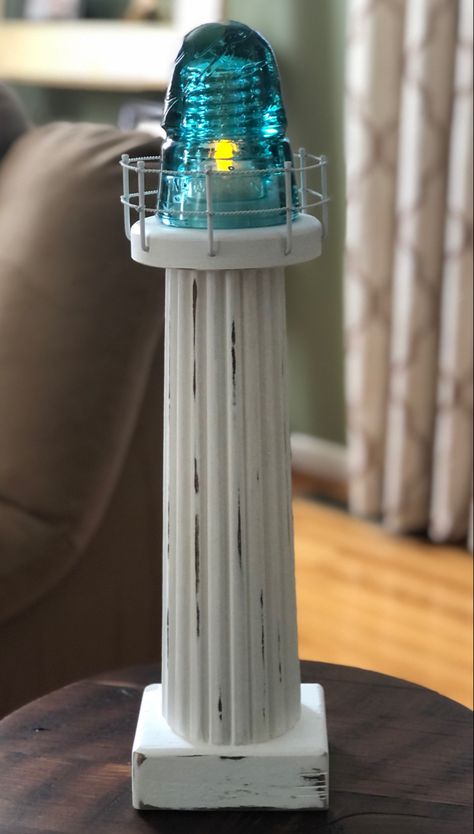 Table leg and antique glass insulator lighthouse. Insulator Lights Diy, Antique Insulators Ideas, Glass Insulator Crafts, Insulators Repurposed Diy, Glass Insulators Repurposed, Insulators Repurposed, Glass Insulator Ideas, Glass Insulator Candle Holder, Electric Insulators