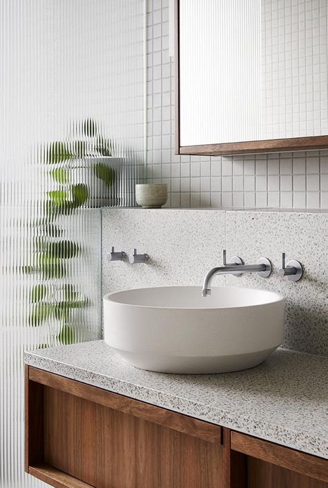 This modern grey bathroom features a glass shower screen that provides a textural element, and above the vanity is small shelf that travels through to the show and creates a place for displaying plants and decorative objects. #ModernBathroom #TexturedShowerScreen #BathroomVanity #Terrazzo #GreyTiles #WoodVanity Terrazzo Tile, Townhouse Designs, Interior Minimalista, Terrazzo Tiles, Grey Bathrooms, Bathroom Renos, Shower Screen, Cheap Decor, Glass Shower