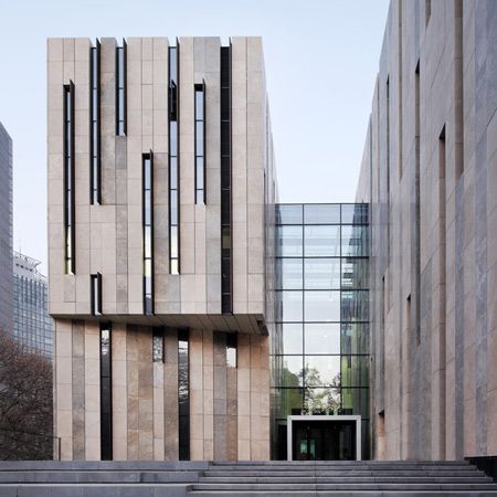 German studio KSP Jürgen Engel Architekten have completed an art museum in Nanjing, China, with a series of narrow rectangular slits across the facade. Called Jiangsu Provincial Art Museum, the building features two u-shaped structures which are joined by a central glass-roofed atrium. The  travertine stone façade is up broken by tall windows, which are Metal Facade, Concrete Facade, Stone Facade, Zaha Hadid Architects, Museum Architecture, Glass Facades, Nanjing, Building Facade, Unique Architecture