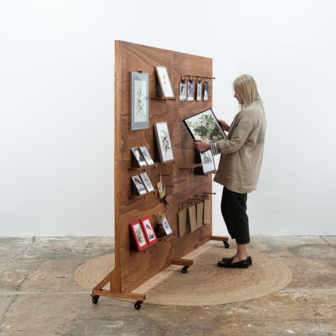 A set of 2 collapsible pegboards creates a large wall that can be used as a booth backdrop as well as a pegboard. The pegboards can be fixed together to create one large board or they can be split in 2 smaller walls that can be used separately. Exhibits cards, art, jewelry and other accessories. The pegs and shelves can be freely adjusted depending on the needs. Pegboard stands on rubber wheels with brakes. The board can be folded and unfolded many times and transported in a compact form to trad Pegboard Freestanding Display, Peg Board Picture Display, Peg Board Art Display, Easy Wood Backdrop, Diy Art Show Display, Photography Booth Vendor, Peg Board Stand, Pegboard Backdrop, Small Gift Shop Interiors