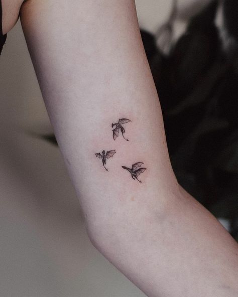 Tiny Dragons Minimalist Tattoos Dragon Tattoo For Women Minimalist, Tiny Dragons Tattoo, Dragon Tattoo Tiny, Dragon Tiny Tattoo, Tiny Tattoo Men, Greek Myth Tattoo Simple, Dragon Tattoo On Finger, Tiny Dragon Tattoos, Girly Dragon Tattoo