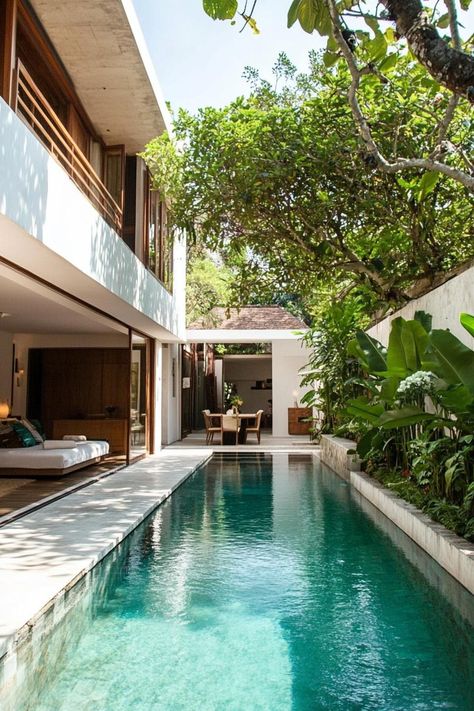 Modern house with a compact pool along the wall tree lined garden. Check out all of these creative small pools in modern homes, transforming limited space into a relaxing oasis. Narrow Pool Small Yards, Pool Small Yard, Pool For Narrow Backyard, Narrow House With Pool, Narrow Lap Pool, Tiny Yard With Pool, Narrow Patio Ideas, Narrow Pool, Outdoor Corridor