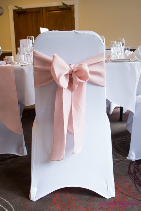 Baby pink chair ribbon on a white chair cover. Part of Gemma & Michaels's real wedding. Table And Chair Decorations For Party, Party Chairs And Tables, Pink Wedding Chairs, Pink Table And Chairs, Ribbon Chairs Wedding, Covered Chairs Wedding, Ribbon On Chairs Wedding, White And Pink Quinceanera Theme, Quince Chair Decorations