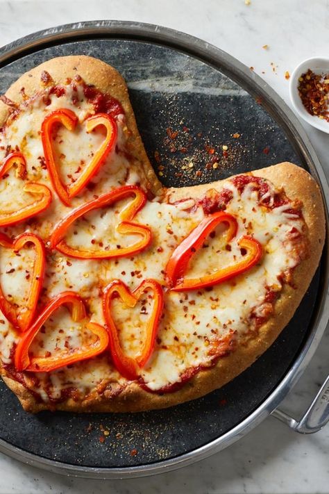 Shaping a round a pizza dough into a heart is an easy way to make a healthy vegetable pizza whimsical and fun. In additional to the heart-shaped dough, slices of red pepper form decorative heart shapes on the pizza. For the most impact, use a pepper that has a deep curve at the stem. #valentinesday #valentinesdayrecipes #recipesfortwo #valentinesdinner #recipe #eatingwell #healthy Pizza Recipe Video, Caprese Pizza, Decorative Hearts, Shaped Pizza, Fruit Pizza Sugar Cookie, Heart Shaped Pizza, Fruit Pizza Recipe, Bell Pepper Recipes, Healthy Vegetable