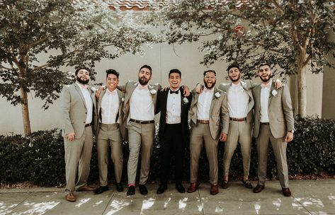 Groom wore a black tux with a black bow tie while his groomsmen wore a crisp tan suit and blush bow ties to match the gals Photo | Chuy Photo Planner | knotsandbelles Black Groom Tan Groomsmen, Tan Groomsmen Suits Black Groom, Black And Khaki Groomsmen, Khaki And Black Groomsmen Attire, Black Tux Groom Tan Suit Groomsmen, Black And Tan Groomsmen, Black And Blush Groomsmen Attire, Mismatched Groom And Groomsmen, Black Suit Tan Tie