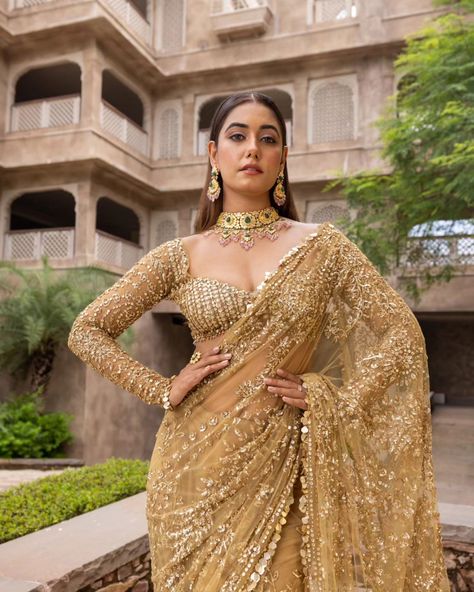 Liquid gold vibes 🌟 ...... MARISTELA - Metallic gold hand embroidered saree with a full sleeve blouse along tassel droplets at waist and gorgeous sequins edging. Cosmos: A Cocktail Affair Discover the collection: Online at Roujeofficial.com via link in bio Calcutta | Hyderabad Jewelry:@gkchudiwalas [ Roujeofficial, rouje, Cosmos, feathered cape, tassels, crystals, sequins, hand embroidery, cocktail saree, party outfits, after party outfit, bridesmaid outfit, Sangeet, wedding day, re... Golden Sangeet Outfit, Cocktail Party Outfit Bride, Gold Blouses For Sarees, Golden Saree Bridal Look, Full Sleeve Blouse Designs Saree Indian Weddings, Lengha Blouse Designs Full Sleeves, Full Sleeve Saree Blouse Design, Full Sleeves Blouse Designs Saree, Reception Outfit Bridesmaid