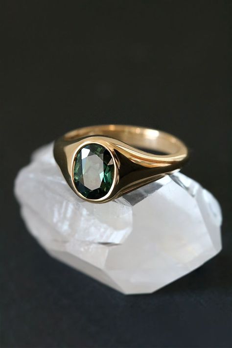 Exude timeless elegance with this unique signet ring. A vibrant 1.95ct Australian sapphire, boasting a deep forest green hue, is showcased in a gleaming 18ct yellow gold setting. Perfect as a statement piece or an alternative engagement ring, its warm tones and luxurious details make it a cherished heirloom. Currently an Australian size M, this one-of-a-kind ring can be resized. Gemstone Rings Men, Signet Engagement Rings, Sapphire Signet Ring, Mens Gold Signet Rings, Stone Ring Design, Mens Ring Designs, Couple Ring Design, Australian Sapphire, Custom Made Engagement Rings