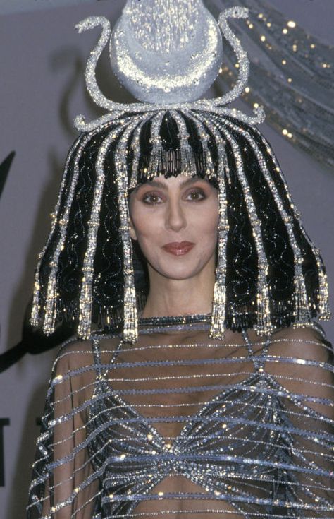 For fashion designer (and good friend) Bob Mackie's 1988 Halloween party, Cher went all out by wearing a glitzy and elaborate Cleopatra-style hairpiece and wig. Cher Icon, Iconic Cher, Cher Wig, Cher Hair, Happy 69th Birthday, Cher Costume, Drag Ideas, Cleopatra Style, Cher Outfits