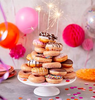 Donuts At Party, Donuts On Cake Stand, Donut Stacked Cake, Donut Birthday Stack, Donuts Stacked Like A Cake, How To Make A Donut Cake Tower, Donut Birthday Tower, Doughnut Stack Cake, Stacked Donut Cake Birthday