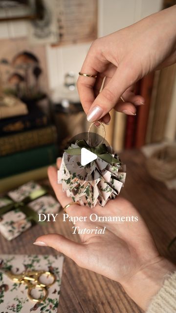 Fable England on Instagram: "DIY Paper Ornaments We’re feeling super crafty this festive season so we are opting to DIY a lot of decor. Here’s how we made these adorable paper ornaments. This is a lovely way to use up pretty wrapping paper you have saved!   What you’ll need: •patterned paper (we used our gift wrap!) •scissors  •tape •glue gun/hot glue •twine  •ribbon •ruler   Instructions:  1. Cut strips as follows:  • 2 strips 2.5cm by 30cm  • 2 strips 3cm by 40cm  • 1 strip 3.5cm by 50cm  (please note if your paper is not long enough you can tape the pieces together as shown in our video) 2. Fold each strip like an accordion about 1cm per fold 3. Use a hot glue gun to glue the ends of each strip together  4. Bend the circle strip inward to form a medallion and add a small drop of hot glu Kraft Paper Ornaments, Twisted Paper Ribbon Crafts, Paper Accordion Ornaments, Wrapping Paper Ornaments Diy, Paper Strip Ornaments, Twine Ornaments Diy, Diy Paper Ornaments, Paper Ribbon Crafts, Paper Ornaments Diy