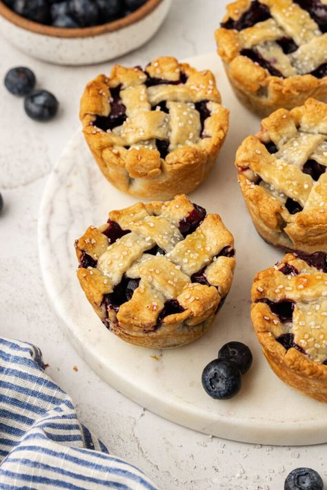 Easy Mini Blueberry Pies Recipe (Made In Muffin Tin!) Blueberry Pie Muffins, Desserts In A Muffin Tin, Blueberry Tart Recipe Easy, Small Blueberry Pie, Cupcake Pan Pies, Blueberry Pie Recipe With Canned Filling, Blueberry Tarts Filling, Mini Blueberry Pies In Muffin Tin, Muffin Tin Pies