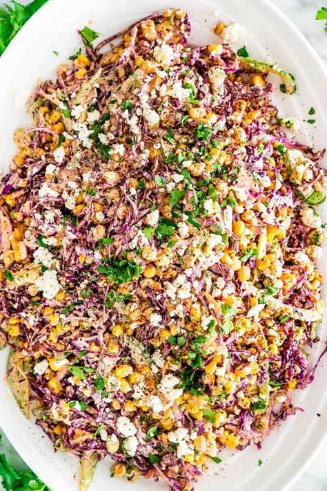 This Mexican Street Corn Slaw recipe is about to be your new favorite side dish! This smoky, creamy slaw complete with sweet charred corn and salty feta cheese will have you hooked from the first bite. #cornslaw #mexicancornslaw #mexicanstreetcorn Corn Slaw Recipe, Mexican Corn Slaw, Street Corn Slaw, Mexican Slaw Salad, Street Taco Slaw Recipe, Slaw For Street Tacos, Corn Slaw For Tacos, Mexican Corn Coleslaw, Mexican Street Corn Slaw