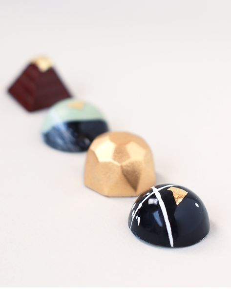 Hand-painted chocolate gems decorated with a kiss of 24K gold leaf. Each gem features a unique design which is an artistic representation of the moon's surface. Includes: 6 hand-painted chocolates Inspiration card that reads: "The Moon is a symbol of power and mystique, a constant reminder of the diverse ways we can shine. Just like the Moon, each of us has different phases, each as fascinating as the next. You are like the Moon, a celestial body illuminating the lives of those around you. You a Chocolate Design Ideas, Gems Chocolate, Painted Chocolate, Mushroom Farm, Christmas Chocolates, Luxurious Chocolate, Chocolate Work, Symbol Of Power, Chocolate Making