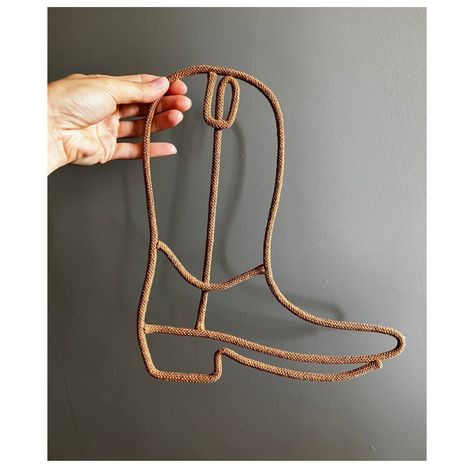 Add a touch of Texas charm to your space with this cowboy boot shape decor for the wall! Handcrafted with attention to detail, this unique piece is the perfect addition to any Western-themed room , nursery ,kids bedroom or country-inspired home. Hang it up in your living room, bedroom, or even in your entryway to showcase your love for all things cowboy. Made from cotton cord and sturdy wire  this wall decor is built to last and will surely be a conversation starter for your guests. Upgrade your Retro Western Nursery, Modern Cowboy Nursery, Rodeo Nursery Theme, Western Cowboy Nursery, Cowboy Theme Nursery Boys, Coastal Cowboy Nursery, Country Theme Bedroom, Nursery Ideas Western, Cowboy Toddler Room