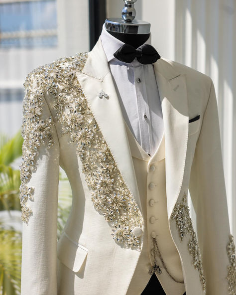 An Ivory White, knitted, horizontal spiral floral pattered, peak lapel tuxedo suit, glass Swarovski stones detailing, tux pant & diamond shaped bow tie. Diamond Suit Men, Wedding Dresses Man, Ivory Tuxedo Wedding, Prom Suit Ideas, White Tuxedo Men, Tuxedo Peak Lapel, Prom Outfits For Guys, Ivory Tuxedo, Grooms Outfit