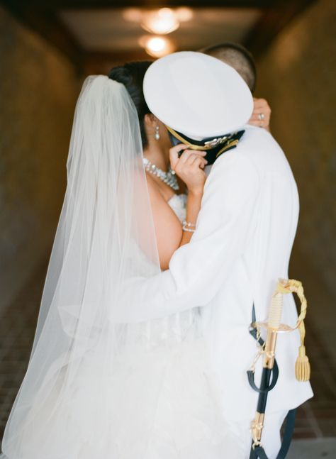 My groom a US Navy Officer in his dress whites and me in my Lazaro wedding dress and cathedral length veil stealing a kiss behind his hat (cover). Navy Engagement Photos, Us Navy Officer, Coast Guard Wedding, Navy Couple, Usmc Wedding, Lazaro Wedding Dress, Army Wedding, The Office Wedding, Marine Wedding