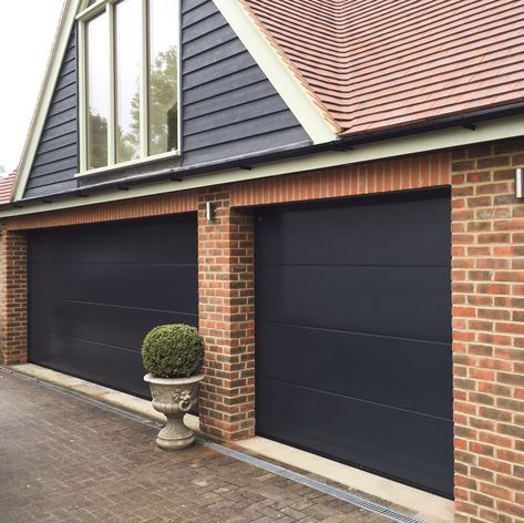 Two beautiful sectional garage doors, one double and one single width. #garage #architecture Garage Architecture, Brown Garage Door, 1930s Semi, Door Treatments, 80s House, Garage Door Hardware, Siding Ideas, Sectional Garage Doors, Modern Garage Doors