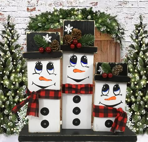 "My whimsical winter snowman family is sure to brighten your holiday. Display on your mantel, table or place on the floor by your Christmas tree. They might be smiling or singing a Christmas carol. This trio of snowmen measure 13\" wide x 13-1/4\" tall x 3-1/2\" deep. The center man snowman measures 12-1/4\" tall The woman snowman measures 10-3/4\" tall. The child snowman measures 7-3/4\" tall. The base and snowmen are made of wood. They are all hand painted with acrylic paint. I attached the hat brim with E6000 glue to make sure it stays put and made sure to tilt them a little for a more whimsical look.  I hot glued the ornaments on the hats. I hand painted the faces and buttons. I love the little carrot noses. The scarfs and bow tie are made of fabric and attached with hot glue. I also f Wooden Crafts For Christmas, Snowman Wooden Crafts, Snowman Wood Crafts Diy, 4 X 4 Christmas Crafts, Snow Man Christmas Decor, Christmas Wood Snowman, Snowmen Wood Crafts, Wooden Crafts Christmas, 2 X 4 Snowman