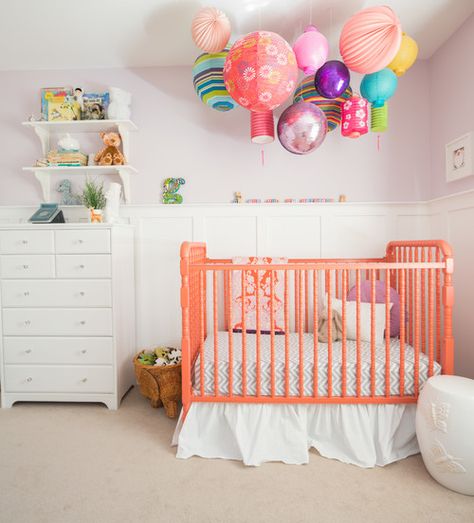 This nursery takes mobiles to the next level with tons of brightly colored paper lanterns and—yup, you’re seeing that right—a disco ball. We’re betting baby will never be bored in this crib. To finish the look, refresh an older crib with a splash of bright coral. Disco Nursery, Transitional Nursery, Modern Nursery Design, Eclectic Nursery, Contemporary Nursery, Girl Nursery Themes, Baby Room Themes