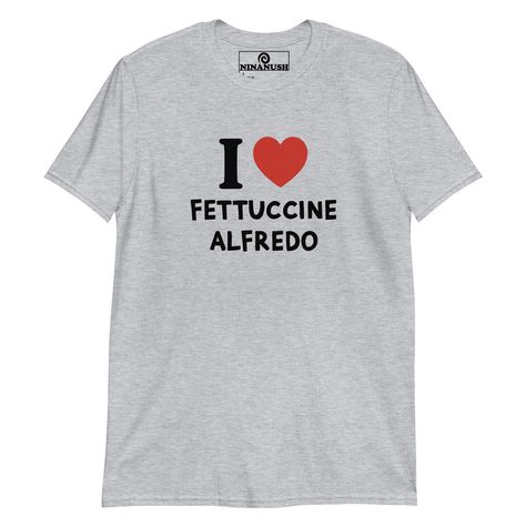 The I love fettuccine Alfredo t-shirt! A classic t-shirt for pasta lovers that stands out and makes a bold statement. Wear this funny foodie shirt and show off your fettuccine passion. It's a soft and comfortable tee, designed for fettuccine Alfredo enthusiasts and made just for you. This quirky shirt is the perfect unique graphic tee to add some personality to your outfits or a funny gift for a fellow fettuccine Alfredo lover.    * 100% ring-spun cotton  * Dark Heather is 65% polyester, 35% cot Foodie Outfit, Quirky T Shirts, Pickled Garlic, Fettuccine Alfredo, Pasta Lover, Weird Holidays, Happy Design, Funny Graphic Tees, Kids Swimwear