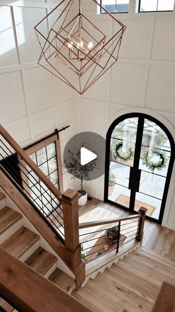 Shelby | Interior Design on Instagram: "The Foyer ✨  The entry to our home was designed with emphasis on creating a separation between our great room and entry, but subtly marrying them together in design.   When our guest arrive, we want it to have a grand feel as they walk through our doors so they truly can embrace the essence of taking a deep breath, walk in relaxing, and be in a space that has a calming vibe. ✨  The Alder beams and trim are two of my most favorite features.   The staircase was custom built and designed for a soft transition into the great room which we love that it’s non-traditional.   Save | Share | Follow @themassonco 🤍   #foyer #foyerdecor #interiordesign #interiordecor #homedesign" Staircase In Foyer, L Shaped Staircase Foyer Entryway, Dual Staircase Entryway Foyers, Stairs In Foyer, Tall Foyer Ideas Entryway, Two Story Entryway Ideas, Foyers With Curved Staircases, Foyer Staircase Entryway, Double Staircase Entrance Farmhouse