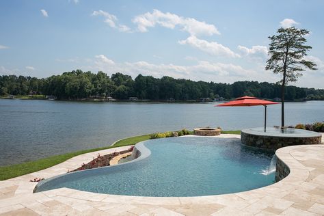 An infinity pool and spa on Hyco Lake, North Carolina. Design and build by Clearwater Construction Group of North Carolina. Lake House With Infinity Pool, Pool By Lake, Pool By The Lake, Lakefront Pool, Small Landscape Design, Hillside Pool, Dream House Pool, Edge Pool, Landscape Design Ideas