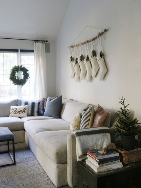 Christmas in the family room | https://jonesdesigncompany.com/decorate/christmas-in-the-family-room/ Behind The Couch Christmas Decor, Above Couch Christmas Decor, Christmas Decor Above Couch, Behind Couch Christmas Decor, Aesthetic Christmas Living Room, Decor Over Couch, Decor Behind Couch, Christmas Living Room Ideas, Decor Above Couch