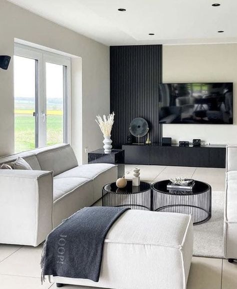 Are you a newbie in designing a dark accent wall but intrigued by its beauty? Check out this design! Instead of painting the entire wall in black, you can choose wall panels and install them halfway up the wall. #BlackWallDecor #DarkFeatureWall #BlackWallIdeas #MinimalistBlackWall #DarkWallPaint #BlackLivingRoomWall #BedroomFeatureWall #BlackWallTrends #LuxuriousBlackWalls Bloxburg Basement, Black Living Room Decor, Modern Apartment Living Room, Black And White Living Room, Bar Basement, Decor Fireplace, Apartment Living Room Design, Black Living Room, Future Apartment Decor