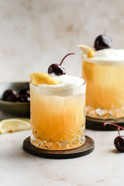 A twist on the traditional whiskey sour. Bourbon combined with orange juice, lemon juice, orange bitters, simple syrup and grenadine and shaken with an egg white for the perfect foam top. #whiskeysour #cocktails #cocktailrecipes #drinkrecipes #happyhour #happyhourdrinks #newyearsevedrinks Whiskey Sour Cocktail, New Years Eve Drinks, Whiskey Sour Recipe, Bourbon Sour, Amaretto Sour, Sour Orange, Whisky Sour, Orange Bitters, Orange Cocktails