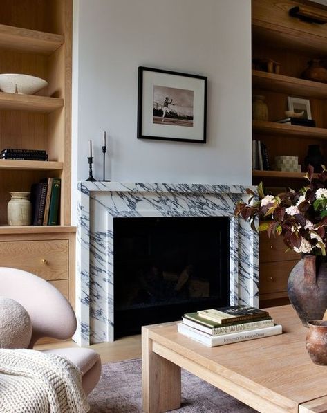 Completely in love with this chic living room! The stunning marble fireplace flanked by rich wood bookcases creates such a perfect balance. Wood and marble—my forever favorite combo! 🤍🔥 Design by @fisherhomela Photo by @jessicajalexander • • • • #LivingRoomGoals #WoodAndMarble #ChicInteriors #InteriorInspiration #DesignInspo #DesignLover #InteriorInspo #DesignDetails #HomeDesign #TimelessElegance Marble Fireplace Surround, Marble Fireplace, Wood Bookcase, Wood And Marble, Chic Living Room, Marble Fireplaces, Fireplace Wall, Humble Abode, Fireplace Design