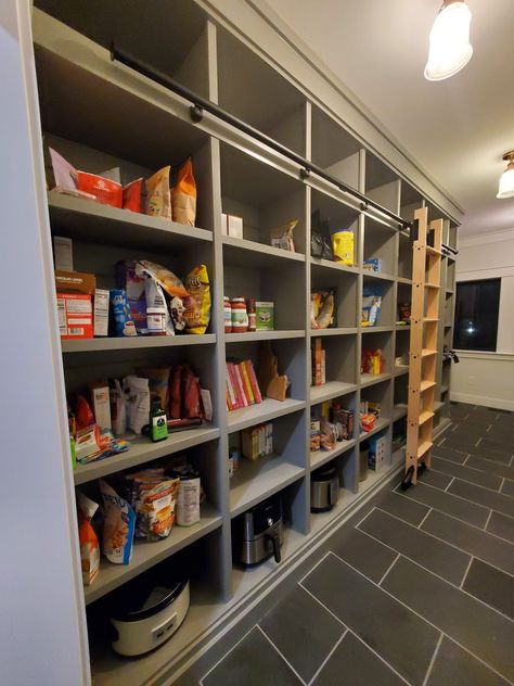 Custom home pantry storage Pantry With Ladder Design, Pantry With Library Ladder, Library Ladder Pantry, Pantry With Ladder, Larder Shelving, Pantry Ladder, Pantry Addition, Space Breakfast, Laundry Room Pantry