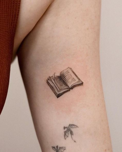 Books Related Tattoos, Tattoo Of A Book, Book Tattoo Inspiration, Cute Book Tattoos For Women, Bird And Book Tattoo, Book Semicolon Tattoo, Tiny Nerd Tattoo, Creative Book Tattoos, Literature Inspired Tattoos