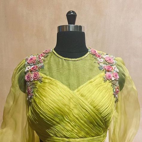 BlouseHousebyMahithaPrasad on Instagram: "Radiant in Neon Green: The Finely Pleated Silk Blouse with Organza Neck and Sleeves designed by Mahitha Prasad breaks stereotypes in the truest sense. Adorned with 3D floral embroidery, created with sequins and pearls, on the shoulders and sleeve cuffs, this masterpiece breaks conventions and defines stereotypes. It's unique colour and contemporary design make it a true showstopper, ensuring you stand out from the crowd. The bow detail on the back wa Pleated Blouse Designs, Organza Blouse Designs, Ruffle Blouse Designs, Maggam Blouses, Maggam Blouse, Bridal Blouses, Aari Blouse, Wedding Saree Blouse, Lehenga Designs Simple