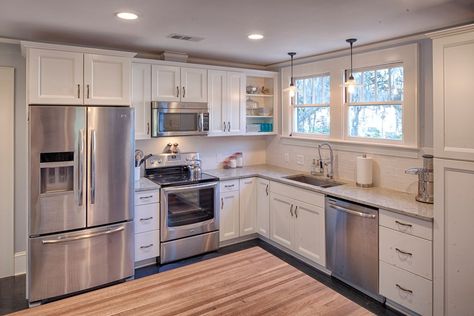 One of the most popular kitchen layouts for apartments and smaller homes, the L-shaped kitchen is highly versatile and able to accommodate a wide variety of different floor plans.   About the L-Shaped Kitchen Consisting of two adjoining lengths of countertops that meet at a corner to form the L, this type of kitchen is great for small to medium sized living spaces because it allows for two walls worth of cabinet space, while also allowing for an open flowing feel. In smaller homes, the more wall Budget Kitchen Remodel, Farmhouse Kitchen Remodel, White Kitchen Remodeling, L Shaped Kitchen, Kitchen Remodel Before And After, New Kitchen Cabinets, Kitchen Remodeling Projects, Dishwashers, Kitchen On A Budget