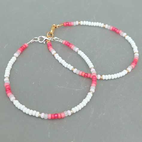 This pink summer seed bead bracelet has been lovingly made using good quality colourful 3mm glass Miyuki and Preciosa seed beads in pinks and white. Available with either 2mm silver or gold Miyuki seed beads to highlight. Threaded on strong stainless steel 7 strand Tiger Tail wire and finished with silver / gold plated wire guardians, a trigger clasp and optional extender chain. Matching necklace available on request. Matching Anklet available on request. More colours and designs can be found at: https://www.etsy.com/uk/shop/CraftHutCornwall BRACELET LENGTHS 6 1/2" Small 7"       Ladies - Small 7 1/2" Ladies - Standard (this is the most common size and generally the size most bracelets are made) 8"       Ladies - Standard Large / Mens - Standard 8 1/2" Ladies - Large / Mens - Standard Larg Pink Beaded Anklet, Pink White Gold Beaded Bracelet, Pink Seed Bead Bracelet Ideas, Small Beaded Bracelets Simple, 2mm Bead Bracelet Ideas, Anklet Bead Ideas, Bracelet Beads Design, Simple Seed Bead Bracelets, Seed Bead Bracelet Designs