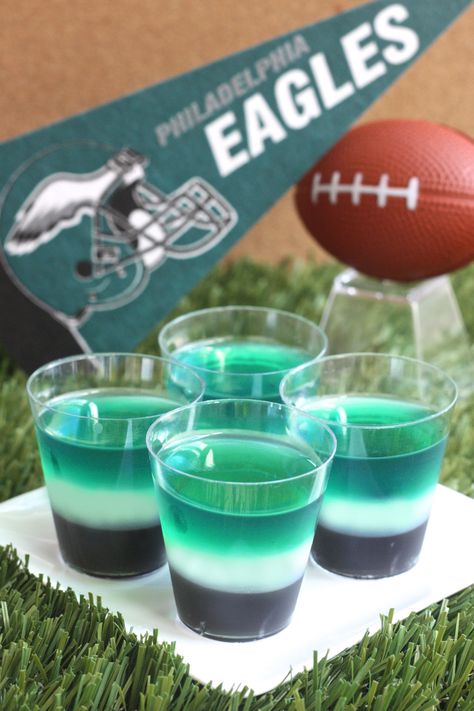 Philadelphia Eagles Jell-O Shots (3 1/2 Tbs grape Jell-O powder 2 3-oz boxes lime Jell-O 3 envelopes Knox plain gelatin  3 cup vodka  Black food coloring 1 cup milk 1/4 cup granulated sugar) Philadelphia Eagles Food Ideas, Philadelphia Eagles Desserts, Eagles Football Party, Philadelphia Eagles Cake, Eagles Party, Superbowl Party Food Ideas, Jell O Shots, Superbowl Sunday, Bowl Party Food