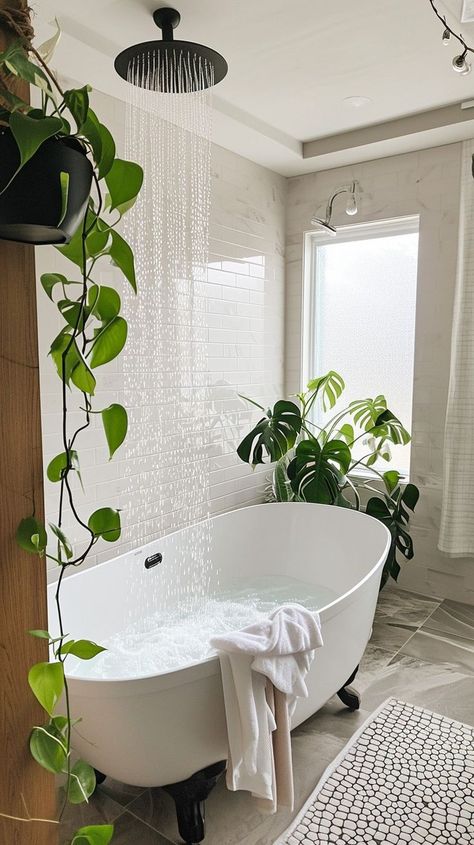 Serene bathroom oasis with a freestanding bathtub, bubbles, green plants, and rain showerhead - ideal for relaxation and tranquility at home Standalone Bathtub Decor, Free Standing Bath Tub Small Bathroom, Bathroom Greenery, Stand Alone Bath Tub, Home Retreat, Relaxing Home, Stand Alone Tub, Serene Bathroom, Bathroom Oasis