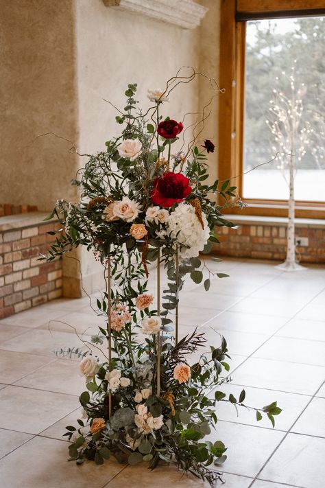 Della Terra Mountain Chateau wedding in Estes Park, indoor wedding ceremony site, floral pedestal Round Tablescapes, Estes Park Wedding Venues, Moody Winter Wedding, Floral Pedestal, Mountain Chateau, Indoor Wedding Ceremony, Church Wedding Flowers, Estes Park Wedding, Indoor Wedding Ceremonies