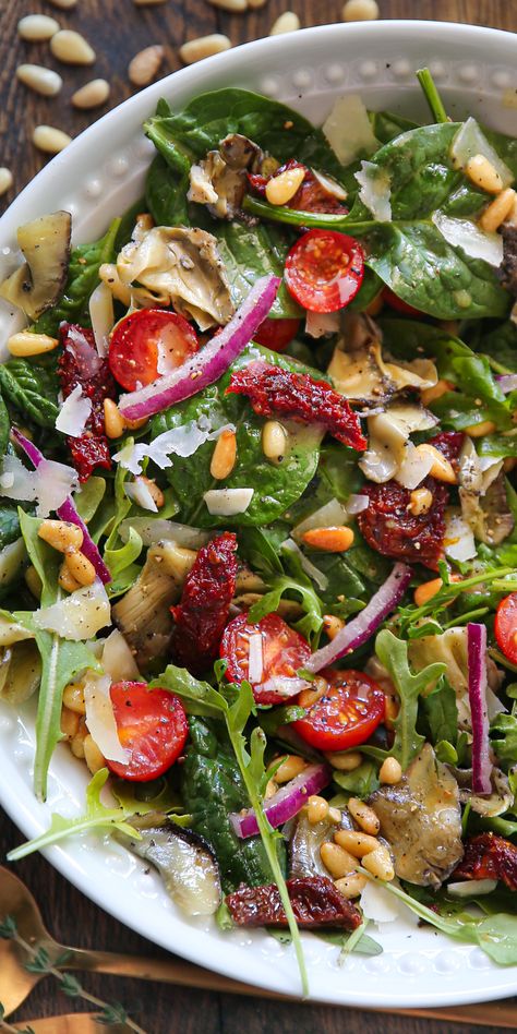 Healthy Italian Salad: a mix of baby Spinach + Arugula, Sun-Dried Tomatoes, Artichokes, Cherry Tomatoes, Pine Nuts, Parmesan - on a white plate. Spinach Tomato Salad, Artichoke Spinach Salad, Mixed Salad, Spinach And Sun Dried Tomato Recipes, Baby Spinach Salad, Sun Dried Tomatoes And Spinach, Arugula Pine Nut Salad, Arugula Sun Dried Tomato Salad, Beat And Arugula Salad