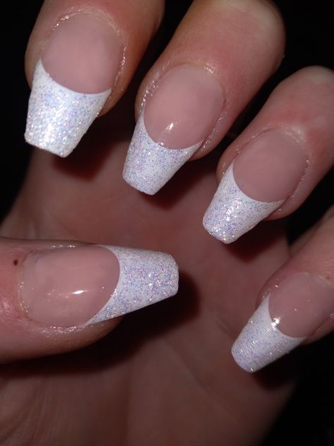 The photo only shows one hand but All 10 of my nails are coffin style. Each have a beautiful, shimmery white French tip topped off with a nice clear glossy top coat. Sparkly French Tips Coffin, Glitter French Tip With Rhinestones, White Nail Silver Tip, Nails For Pageant, White French Glitter Nails, Glitter French Tips Coffin, White Sparkle French Tip, Glittery White French Tip Nails, French Tip Sparkly Nails